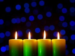 Four candles on blurred light background Stock Footage