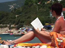 HD: Reading On The Beach Stock Footage