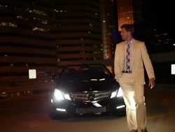 MS TU Well dressed young man walking around his modern convertible car at night in urban area / Minneapolis, Minnesota, United States Stock Footage
