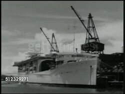 1941: U.S. NAVY: U.S.S. LANGLEY: INT WS US Sailors cleaning torpedo propellers. LA WS Aircraft carrier USS Langley (CV-1) in dock. HA WS Sailors at attention on deck. MS Officers saluting. (formerly USS Jupiter (AC-3)). Instructional Video