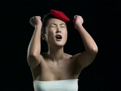 Woman wearing red hat with head in hands Stock Footage