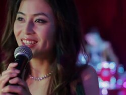 CU Woman singing on stage in night club / China Stock Footage