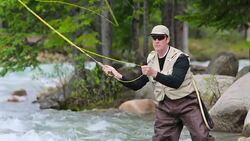 Man fly fishing on a mountain river Stock Footage