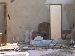 MCU zooming out to MS Tornado damage - Arm chairs in wrecked house with walls and roof missing, sunny, USA Stock Footage