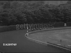 1953: BELMONT PARK: SUBURBAN HANDICAP: MS Press Room, VS RACE, HA LS Horses racing into first turn, WS Crowd, some people w/ umbrellas, horses into stretch, 'Tom Fool & 'Royal Vale' battle for first, neck & neck, nose finish. [VO Fred Caposela] Instructional Video