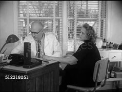 1952: THE ELKHORN CLINIC: VS Elkhorn Clinic building & sign. INT VS Dr. E.D. Sorenson seeing female patient, talking about health & baby (SOT), taking blood pressure. Wisconsin, WI, hospital, check up Instructional Video