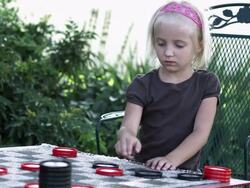 Slow pan of two little girls playing checkers Stock Footage