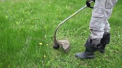 Close up of a man cutting grass Stock Footage