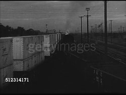 1947: CLEVELAND EXPORT/IMPORT: OHIO: EARLY MORNING: WS Male looking out the window, station conductor behind him. HA WS Cargo trains passing each other on railroad tracks. BRIEF LA MS Terminal Tower building, clouds BG. OH Instructional Video