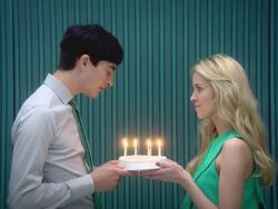 Young couple blowing out candles on birthday cake Stock Footage