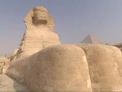 The Great Sphinx sits in front of the Great Pyramids. Stock Footage