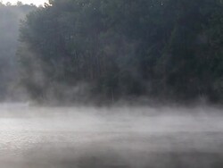 Traveler rafting on the lake in fog Stock Footage