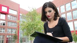 Pretty Woman Taking Notes and Smiles Stock Footage