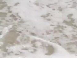 Footprint Being Washed Away By Wave Stock Footage