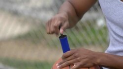 A young man basketball player inflating basketball. Stock Footage