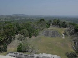 Woman overlooks the Xunantunich temple in Belize Stock Footage