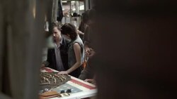 Group of friends look at and try on antique rings and chat with shop owner in Texas ghost town Stock Footage
