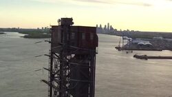 Aerial looking south to Philadelphia skyline over truss bridge on Delaware River Stock Footage