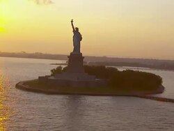 WS AERIAL View of statue of liberty at sunset with water / New York, United States Stock Footage