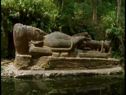Reclining god statue in forest, Bandhavgarh National Park, India Stock Footage