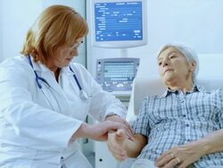 Female doctor checking the senior womans pulse on the wrist Stock Footage