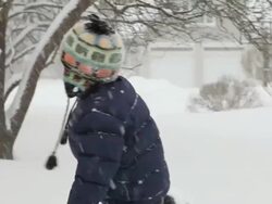 MS PAN boy rolling and frolicking in snow during snow storm / Yarmouth, Maine, USA Stock Footage