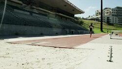 Female long jumper running and jumping Stock Footage
