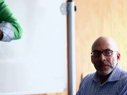 CU PAN TD R/F Mature businesswoman standing holding digital tablet in discussion with coworkers at whiteboard/Washington, USA Stock Footage