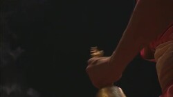 Hindu monks ring a bell and move a platter of stacked candles for puja during a Diwali celebration in India. Stock Footage