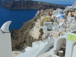 MS PAN Shot of Oia Cyclades white buildings, bell and steep mountains Greek Islands beautiful peaceful place Greek / Santorini, Greece Stock Footage