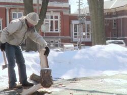 MS Young man determined to chop log with his axe in winter day / Toronto, Ontario, Canada  Stock Footage