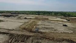 High Day Time Sunny Angle Construction Yard Stripped Acres of Land Over Aerial Drone View With Dramatic Sunset background Austin Texas Round Rock TX New Home Community Stock Footage