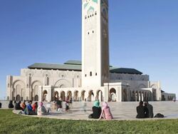 MS T/L People sitting outside of hassan II mosuqe thirld largest in  world / Casablanca, Morocco Stock Footage