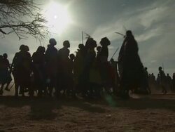 Maasai Ceremony - Warriors dancing in circle, low angle medium shot, silhouetted, WITH AUDIO Stock Footage