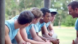 Team leader motivating team at boot camp obstacle course Stock Footage