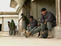 MS Police officer sitting outdoors / Musa Qala, Helmand Province, Afghanistan. Stock Footage