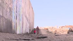 Mother and toddler at West Bank wall News Clip