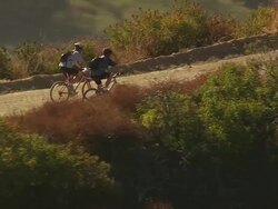 Aerial TS LA two cyclists riding on mountain bikes in Topanga State Forest / Los Angeles, California, Unietd States. Stock Footage