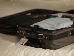 CU Woman in bedroom closing zip of suitcase / Los Angeles, California, United States    Stock Footage