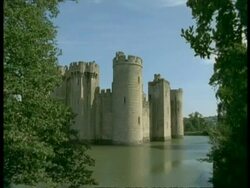 Bodiam Castle, Sussex - framed by trees, river Rother in foreground Stock Footage