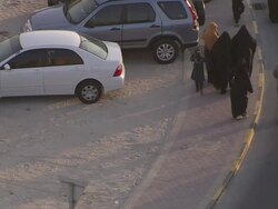 MS Totally covered women in black cloth walking along car parking lot / Manamba ,Bahrain Stock Footage