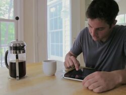 MS Young man using credit card and digital tablet at kitchen table / Lorton, Virginia, United States Stock Footage