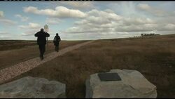 People visiing Argentine cemetery in the Falklands News Clip