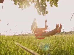 SLO MO Girl having fun swinging on a tree swing Stock Footage