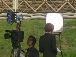MS PAN Shot of television news crews working outside during G8 meeting / Hokkaido Toyako, Japan Stock Footage