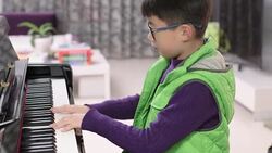 boy playing the piano Stock Footage
