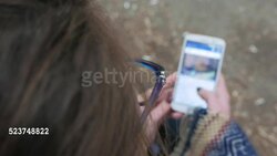 First person view of a girl scrolling on her smart phone Stock Footage