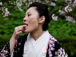 Japanese Kimono Woman Eating Candy Stock Footage