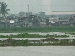 Flood waters in downtown Manila near slum area, Philippines, Typhoon Mirinae 2009 Stock Footage