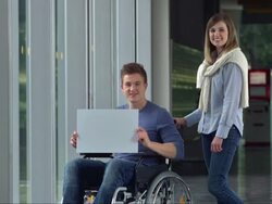 LS Young Man In Wheelchair Holding A Billboard Stock Footage